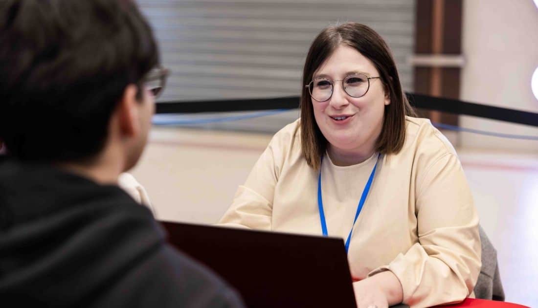 La recruiter Cristina scambia due chiacchiere con uno dei ragazzi intervenuti all'ApeRecruiting mentre gli fa un Colloquio